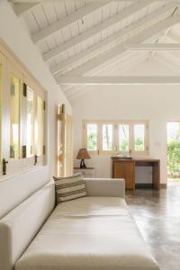 a living room with a white couch and a desk at Kurulu Bay in Ahangama