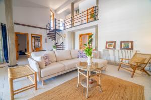 a living room with a couch and a table at RostoIl Espai de Calma in Muro