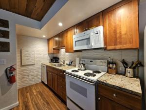 a kitchen with a white stove and a microwave at Cartwright Corner Condo townhouse in Incline Village