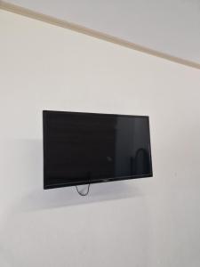 a flat screen tv hanging on a wall at Christina Studios in Kefalos