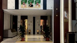 a lobby with two potted plants in a building at فندق جادة الغمامة in Medina
