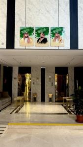 a lobby of a building with posters on the wall at فندق جادة الغمامة in Medina