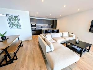 a living room with two couches and a table at Harbour view-Sleeps 4-Sea View-Parking-Balcony in Ramsgate