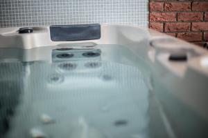 a bath tub with a stove in a bathroom at Penzión Altmayer in Banská Štiavnica +40 photos