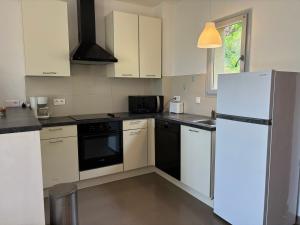 a kitchen with white appliances and a white refrigerator at ELENA in Conca