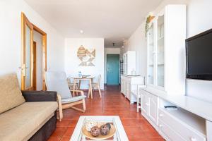 a living room with a couch and a table at aldea 3 4 1ºB in Novo Sancti Petri
