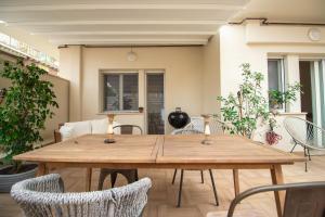 a wooden table and chairs in a room at Le Case di PA in Anzio