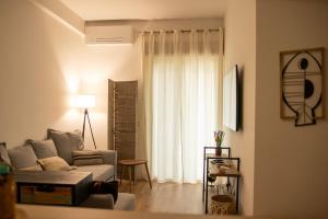 a living room with a couch and a window at Le Case di PA in Anzio