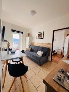 a living room with a couch and a table at Apartments Antonio in Pag