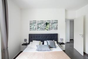 a bedroom with a large bed with a black headboard at Lovely Tiresia Apartment in Sperlonga