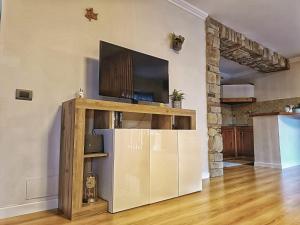 a living room with a tv on a wall at Residenza del Colle in Montelanico