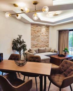 a living room with a table and a couch at Casa Lyristis in Faliraki