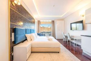 a hotel room with a bed and a dining room at republica83-Lisbonhome in Lisbon