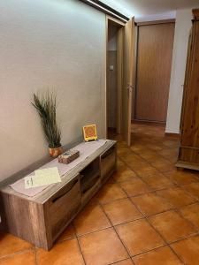 a large room with a bench on a tiled floor at Sisi apartman in Esztergom