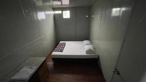 a small room with a small bed in it at Hostel 59 in Sibu