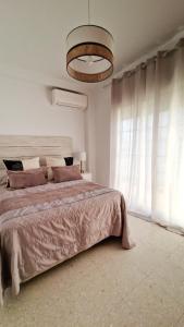a bedroom with a large bed and a large window at Brisas de Europa in Nerja