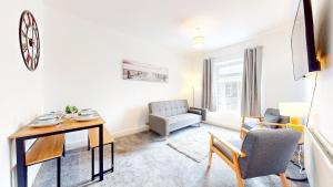 a living room with a table and chairs at 1 Bed Flat Swansea -free parking in Clydach