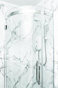 a bathroom with a shower with white marble at 3BR Home Next to Stadium Near Airport Sleeps 7 in Edinburgh