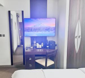 a desk in a room with a picture on the wall at En-Suite Family Room Central London in London