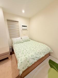 a small bedroom with a bed in a room at WAYNderer's Haven in Davao City +23 photos