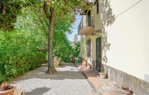 a tree in a sidewalk next to a building at Awesome Apartment In Il Ferrone in Mercatale Val Di Pesa