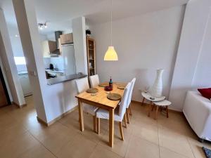 a kitchen and dining room with a table and chairs at CONDADO DE ALHAMA PENTHOUSE 8 SV33 in Alhama de Murcia