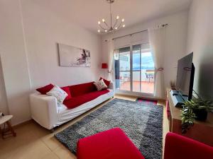 a living room with a white couch and a red rug at CONDADO DE ALHAMA PENTHOUSE 8 SV33 in Alhama de Murcia