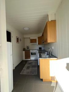 a small kitchen with a sink and a stove at Bua in Viksdalen