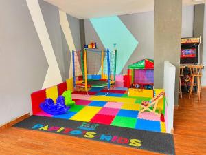 a childs room with a play set and toys at Pousada Papito Ubatuba - Praia Perequê-Açu in Ubatuba