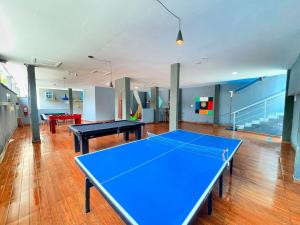 a large room with two ping pong tables in it at Pousada Papito Ubatuba - Praia Perequê-Açu in Ubatuba