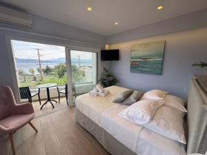 a bedroom with a large bed and a table with chairs at Eleftherias Suites - Near Beach Apartments in Marathi