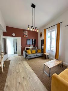 a living room with a couch and a table at Elegant 2 Bedroom Apartment with Free Parking Paris St-Denis by Immo Kit BNB in Saint-Denis