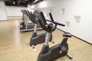 a row of exercise bikes in a gym at Boutique Apartment Carso Alameda-1102 in Mexico City