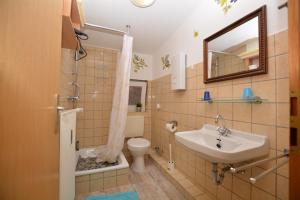 a bathroom with a sink and a toilet and a mirror at Appartment Vermietung Lütje in Büsum +85 photos