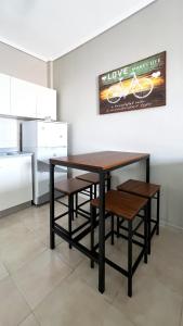 a dining room table with chairs and a bike on the wall at Rona Vista Suites cozy veranda in Polychrono +21 photos