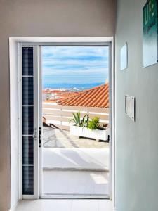 a door leading to a balcony with a view at Rona Vista Suites cozy veranda in Polykhrono
