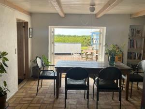 a dining room with a wooden table and chairs at The Fishermen's House - charming and close to beach in Thisted