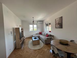 a living room with a couch and a table at Apartman Stević in Vrnjci