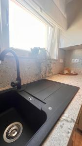 a kitchen counter with a sink and a window at Mint Bellavista in Vir +25 photos