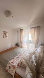a bedroom with a large bed and a window at Mint Bellavista in Vir