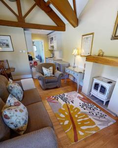 a living room with a couch and a fireplace at Rowsley Cottage Bakewell Peak District in Bakewell