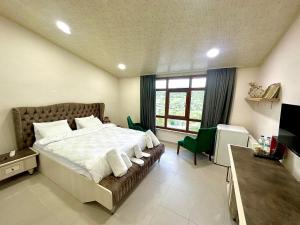 a bedroom with a large bed with towels on it at Kaşkaloğlu Hotel in Arapkir +70 photos