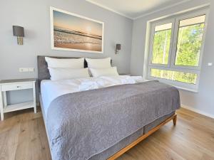 Ένα ή περισσότερα κρεβάτια σε δωμάτιο στο Lychenseevilla mit Seeblick, Wintergarten, Kamin und Sauna +19 φωτογραφίες