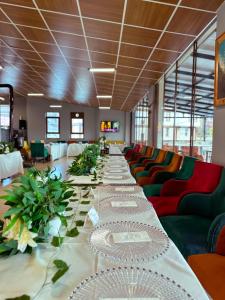 Una mesa larga en una habitación con sillas verdes. en Kaşkaloğlu Hotel, en Arapkir 32 fotos más