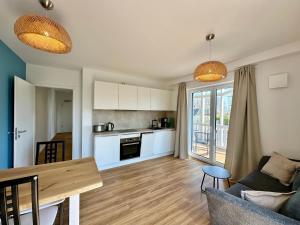 a living room with a couch and a table at Salt & Sand Wohnung Sea in Haffkrug