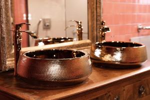 two copper sinks on a counter in a bathroom at Le domaine de rountz in Rountzenheim +65 photos