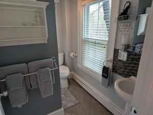 a bathroom with a sink and a toilet and a window at Bourne Bed and Breakfast in Ogunquit +72 photos