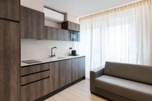 a kitchen with a sink and a chair in a room at Apartamentos Ca Gracia 1 Estándar in Bocairent