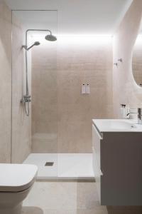 a bathroom with a shower and a toilet and a sink at Apartamentos Ca Gracia 1 Estándar in Bocairent