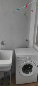a laundry room with a washing machine and a sink at Alojamientos Rías Baixas in Vilagarcia de Arousa